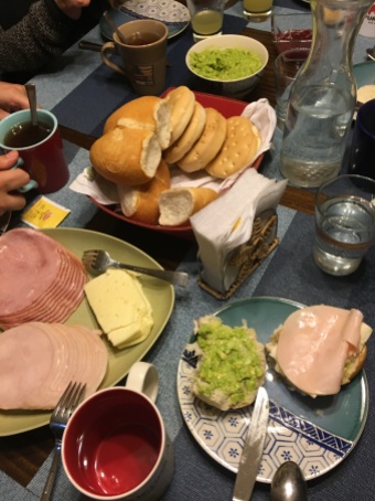 Typical "once" of bread, meat, cheese, avacado, marmelade, and tea.